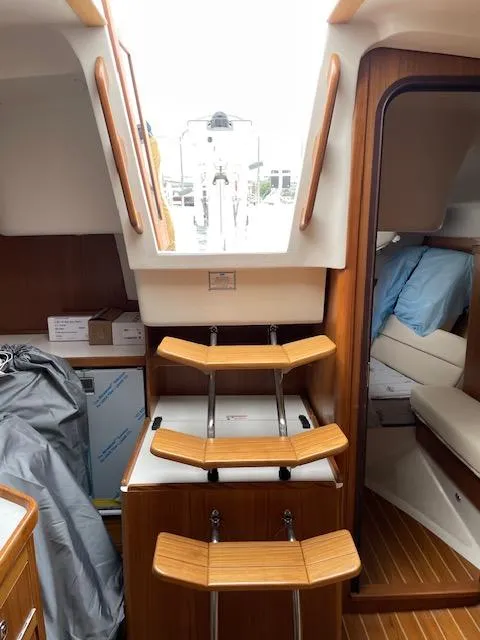 Slide: The Image of Interior of 2025 Catalina 386 sailboat with wooden steps and cozy cabin. - 8