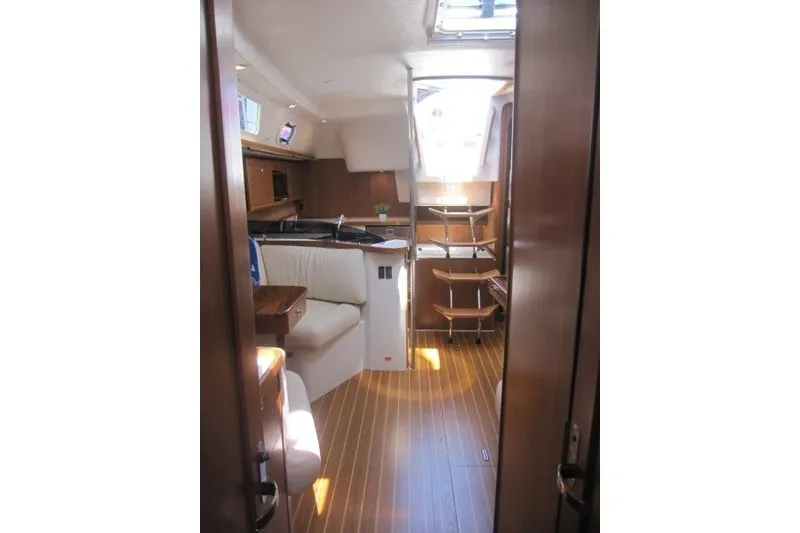 Slide: The Image of Interior of 2025 Catalina 386 yacht with wooden flooring and cozy seating area. - 30