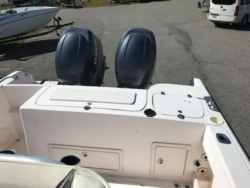 Slide: The Image of 2021 Grady-White 257 Fisherman boat with dual outboard engines in a parking area. - 16
