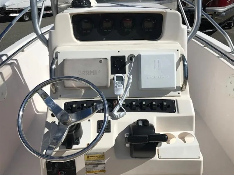 Slide: The Image of 2021 Grady-White 257 Fisherman boat console with steering wheel and controls. - 18