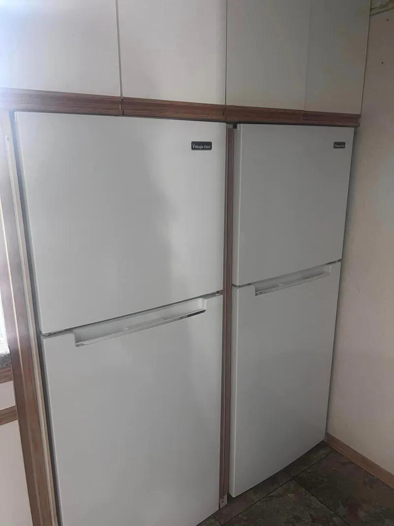 Slide: The Image of Two white refrigerators inside a 1993 Fun Country houseboat kitchen. - 11