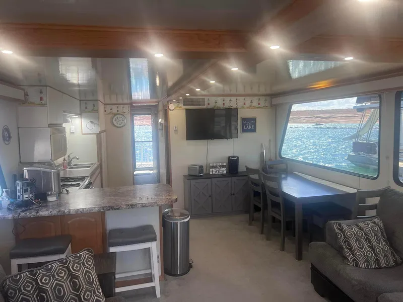 Slide: The Image of Interior of a 1993 Fun Country houseboat with kitchen, dining area, and lake view. - 15