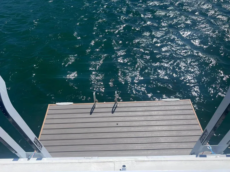 Slide: The Image of Houseboat deck with ladder overlooking sparkling water, Fun Country model, 1993. - 16