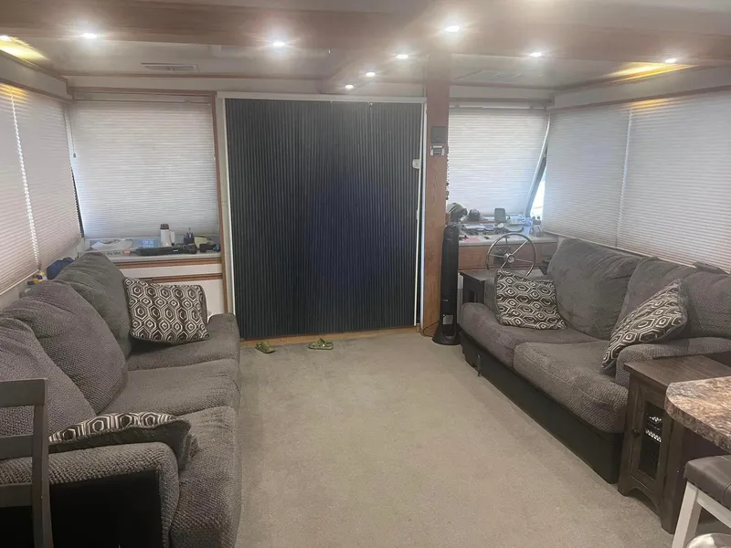 Slide: The Image of Cozy interior of a 1993 Fun Country houseboat with plush sofas and ambient lighting. - 4