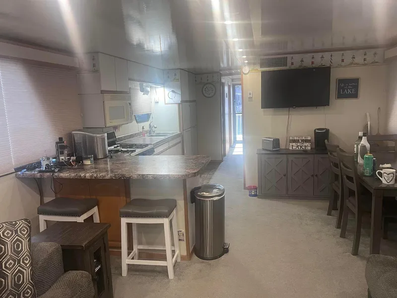 Slide: The Image of Interior of a 1993 Fun Country houseboat with kitchen, dining area, and modern amenities. - 8