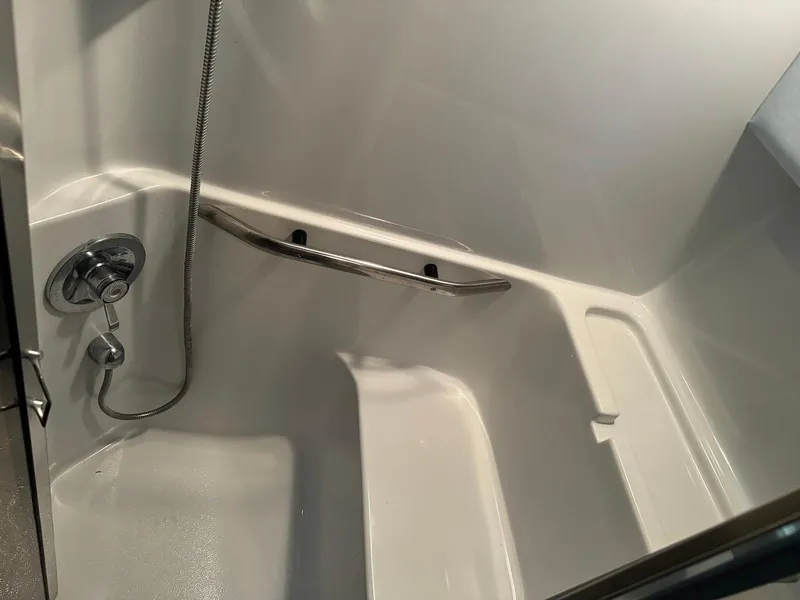 Slide: The Image of Shower area in 1988 Sea Ray 345 Sedan Bridge boat, featuring a sleek design. - 12