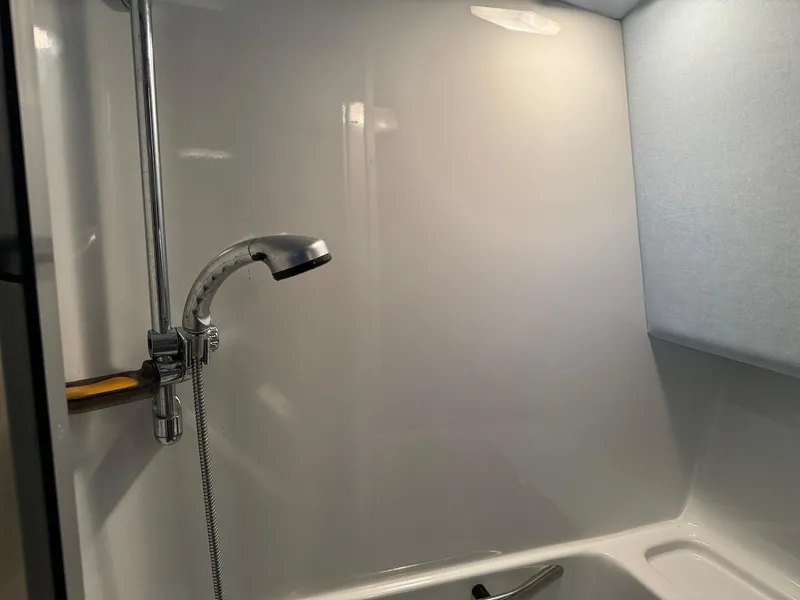 Slide: The Image of Shower area in 1988 Sea Ray 345 Sedan Bridge boat, featuring a sleek chrome showerhead. - 13