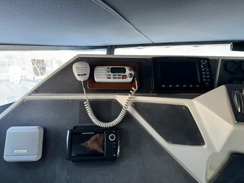 Slide: The Image of Control panel of a 1988 Sea Ray 345 Sedan Bridge with navigation equipment. - 16