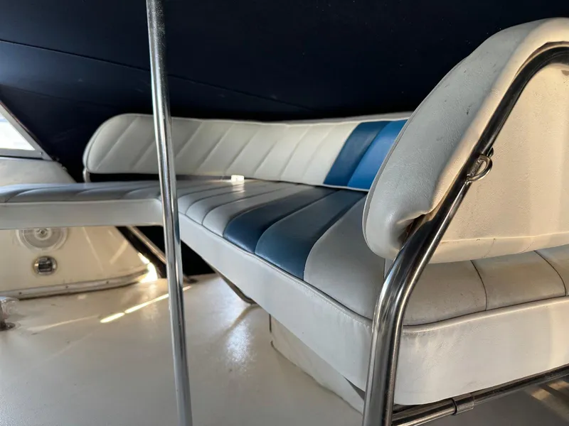 Slide: The Image of Interior seating of 1988 Sea Ray 345 Sedan Bridge with blue and white upholstery. - 18