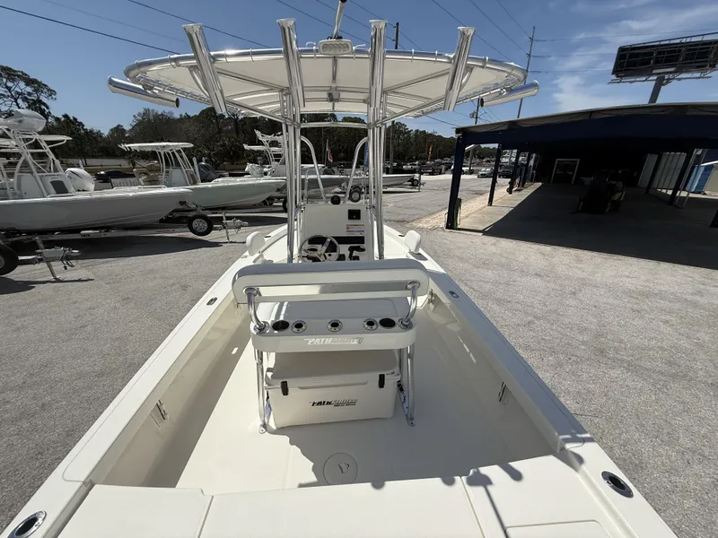 Slide: The Image of 2025 Pathfinder 2200 TRS boat with T-top and console, displayed outdoors. - 10