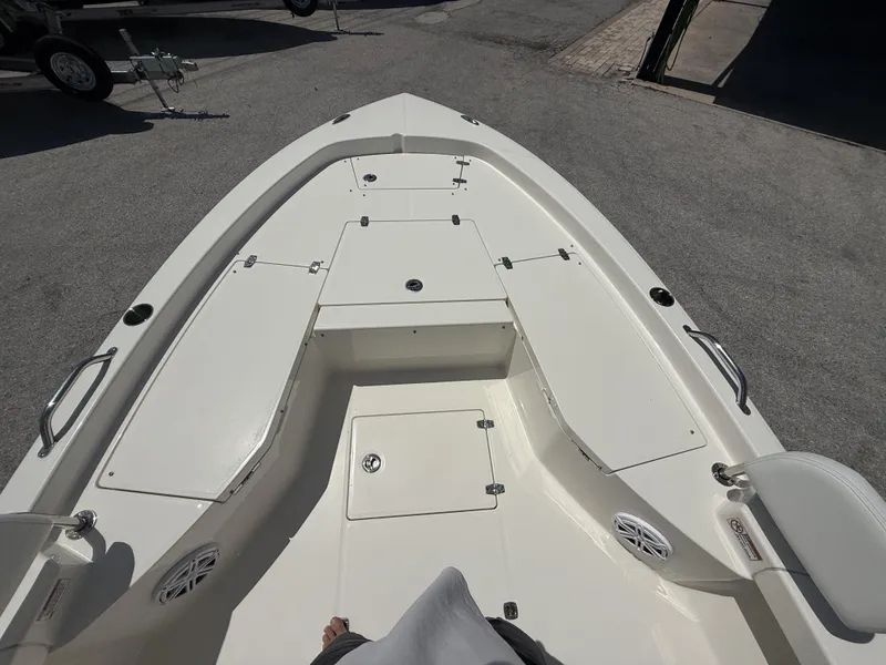Slide: The Image of 2025 Pathfinder 2200 TRS boat deck with storage compartments and seating. - 12
