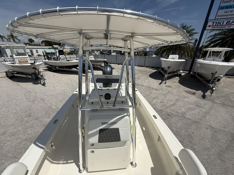 Slide: The Image of 2025 Pathfinder 2200 TRS boat with T-top, parked outdoors under clear skies. - 15