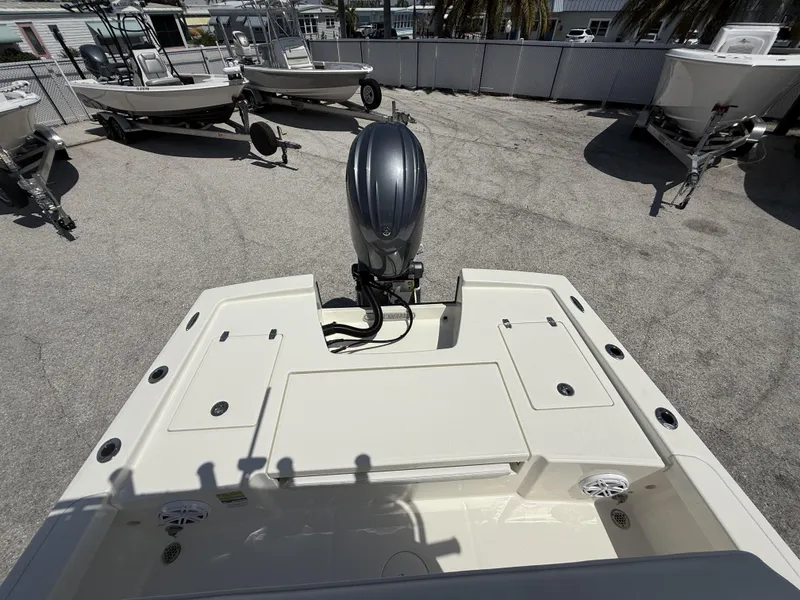 Slide: The Image of 2025 Pathfinder 2200 TRS boat with outboard motor in a dealership lot. - 16