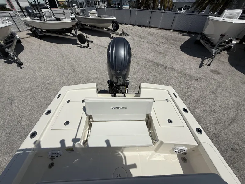 Slide: The Image of 2025 Pathfinder 2200 TRS boat with outboard motor, displayed in a dealership lot. - 17
