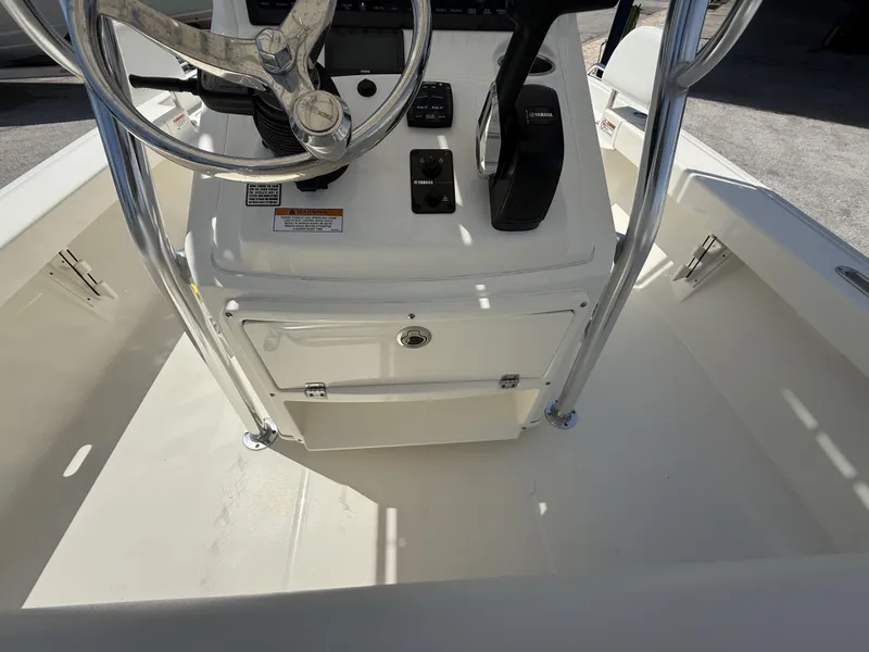 Slide: The Image of 2025 Pathfinder 2200 TRS boat console with steering wheel and controls. - 18