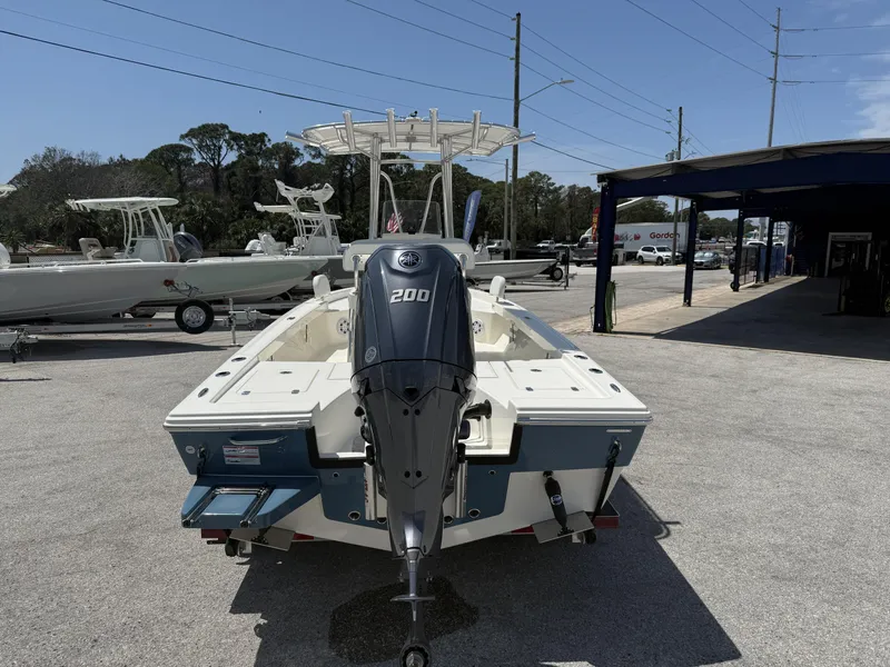 Slide: The Image of 2025 Pathfinder 2200 TRS boat with Yamaha 200 engine, parked outdoors. - 23