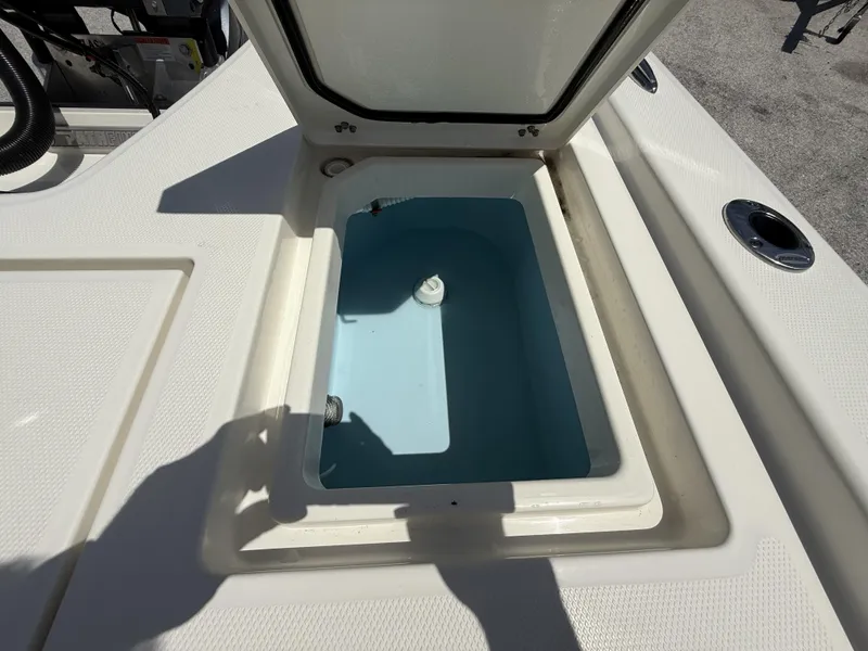 Slide: The Image of Open storage compartment on 2025 Pathfinder 2200 TRS boat, showing interior details. - 30