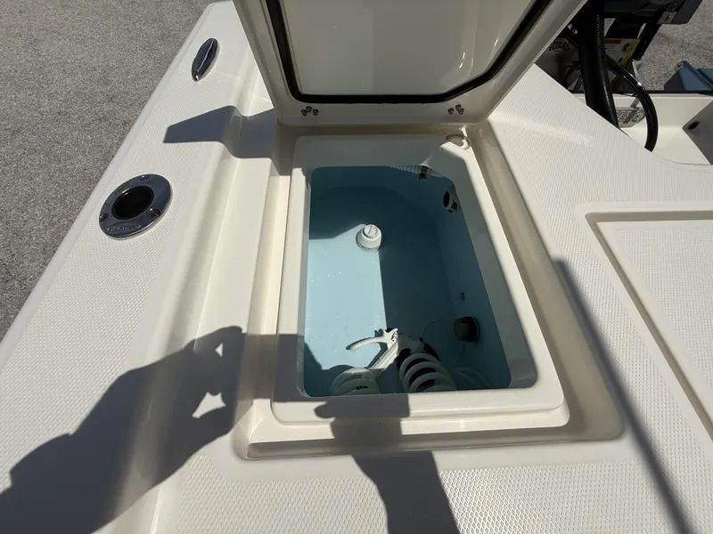 Slide: The Image of Open storage compartment on 2025 Pathfinder 2200 TRS boat, showing interior details. - 31