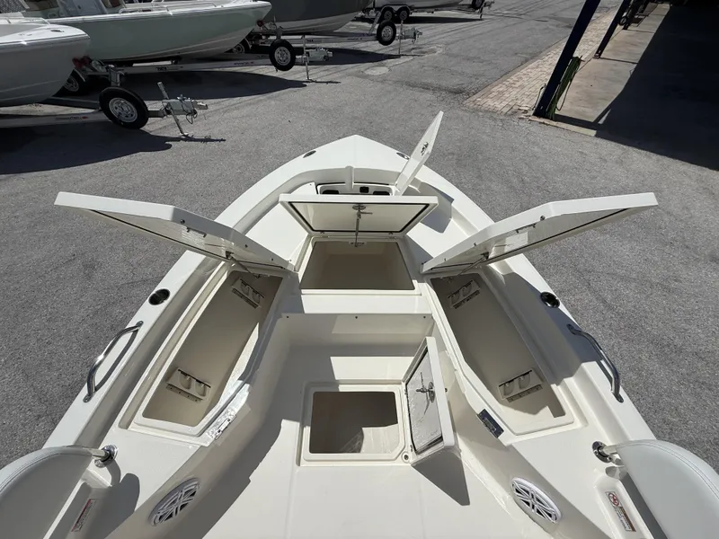 Slide: The Image of 2025 Pathfinder 2200 TRS boat with open storage compartments, displayed on a trailer. - 32
