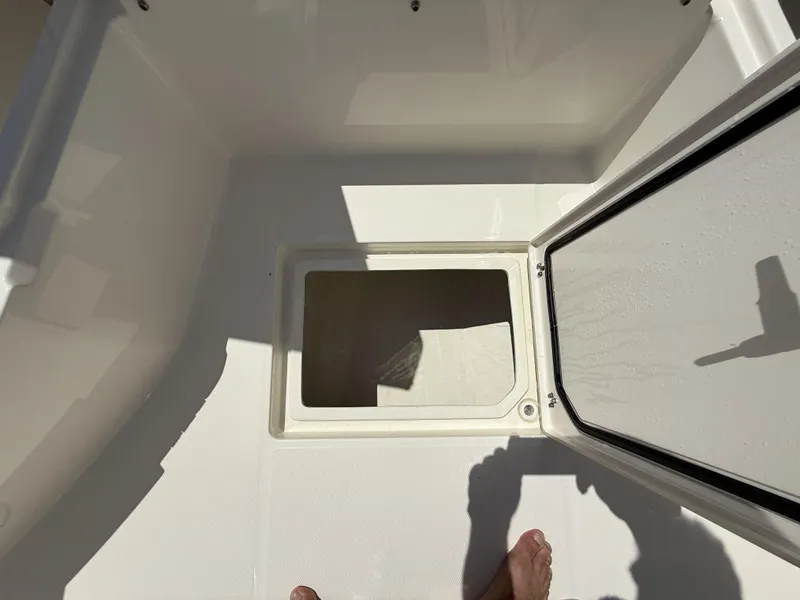 Slide: The Image of Open storage compartment on a 2025 Pathfinder 2200 TRS boat deck. - 33