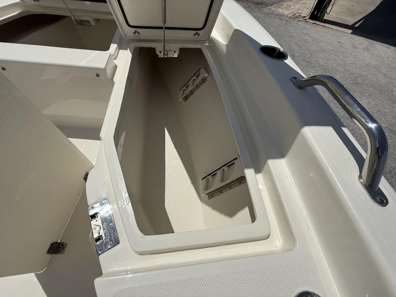 Slide: The Image of Open storage compartment on 2025 Pathfinder 2200 TRS boat, showcasing interior space. - 34