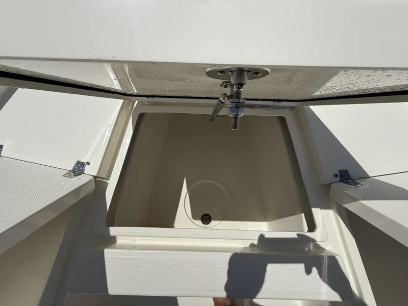 Slide: The Image of Open storage compartment on 2025 Pathfinder 2200 TRS boat, showing interior details. - 35