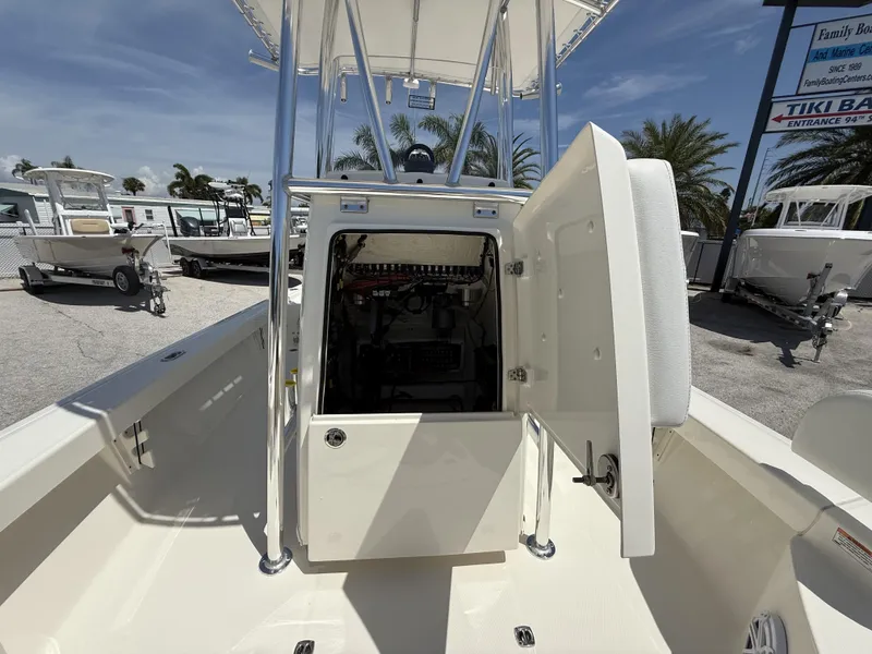Slide: The Image of 2025 Pathfinder 2200 TRS boat with open console storage, parked outdoors. - 37