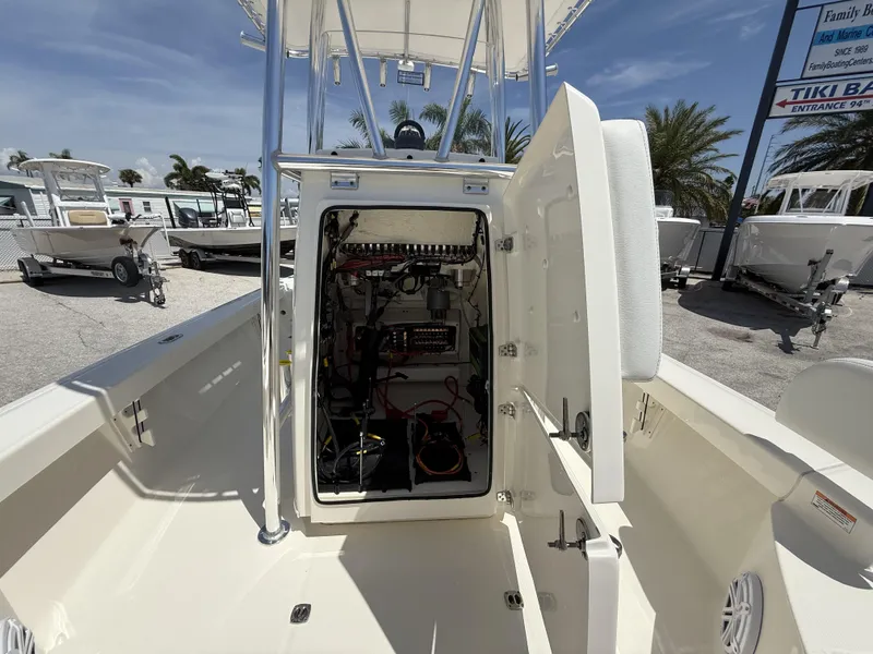 Slide: The Image of 2025 Pathfinder 2200 TRS boat interior with open storage compartment, showcasing wiring and equipment. - 38