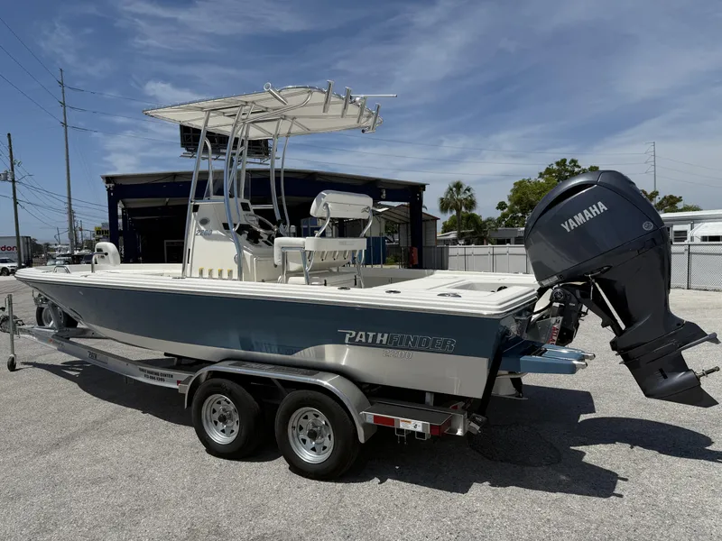 Slide: The Image of 2025 Pathfinder 2200 TRS boat with Yamaha engine on a trailer, parked outdoors. - 4