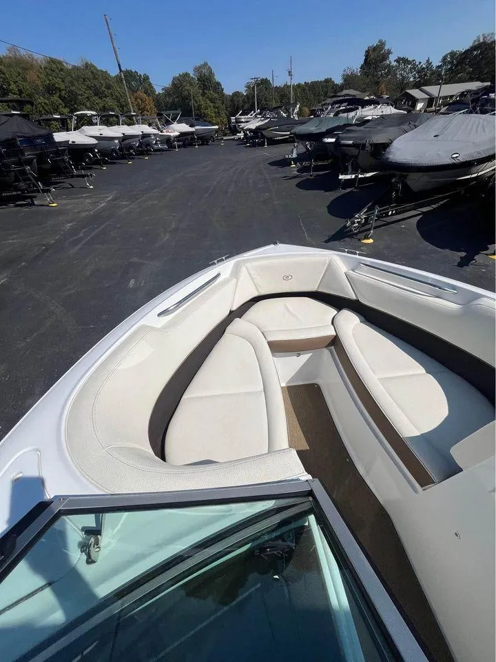 Slide: The Image of 2017 Cobalt 220S boat with white interior, parked among other boats. - 5