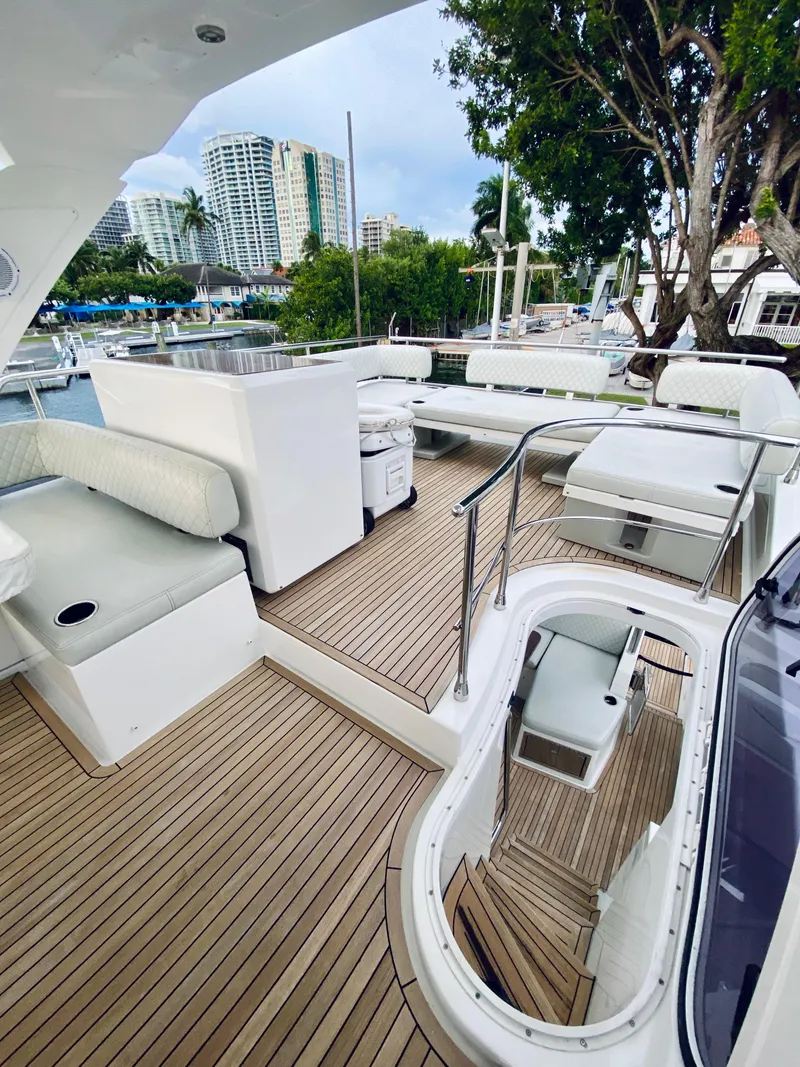 Slide: The Image of Spacious deck of 2015 Azimut 50 yacht with modern seating and cityscape view. - 10