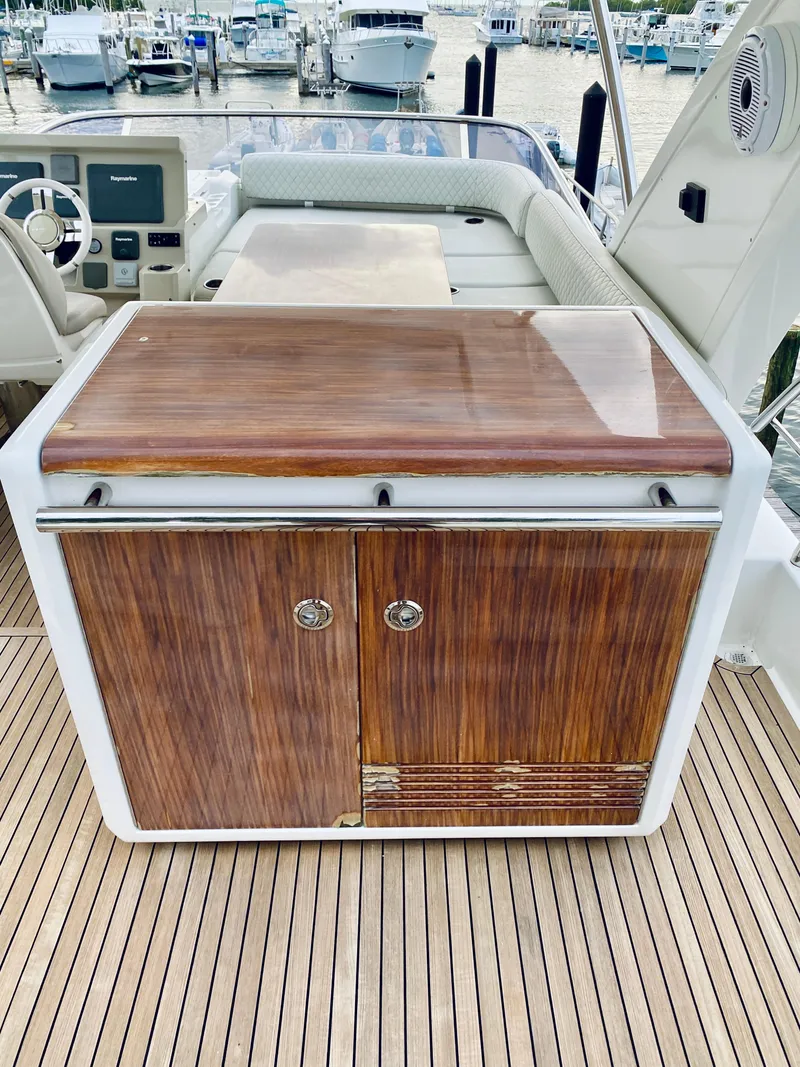 Slide: The Image of Wooden cabinet on 2015 Azimut 50 yacht deck, with marina view. - 16