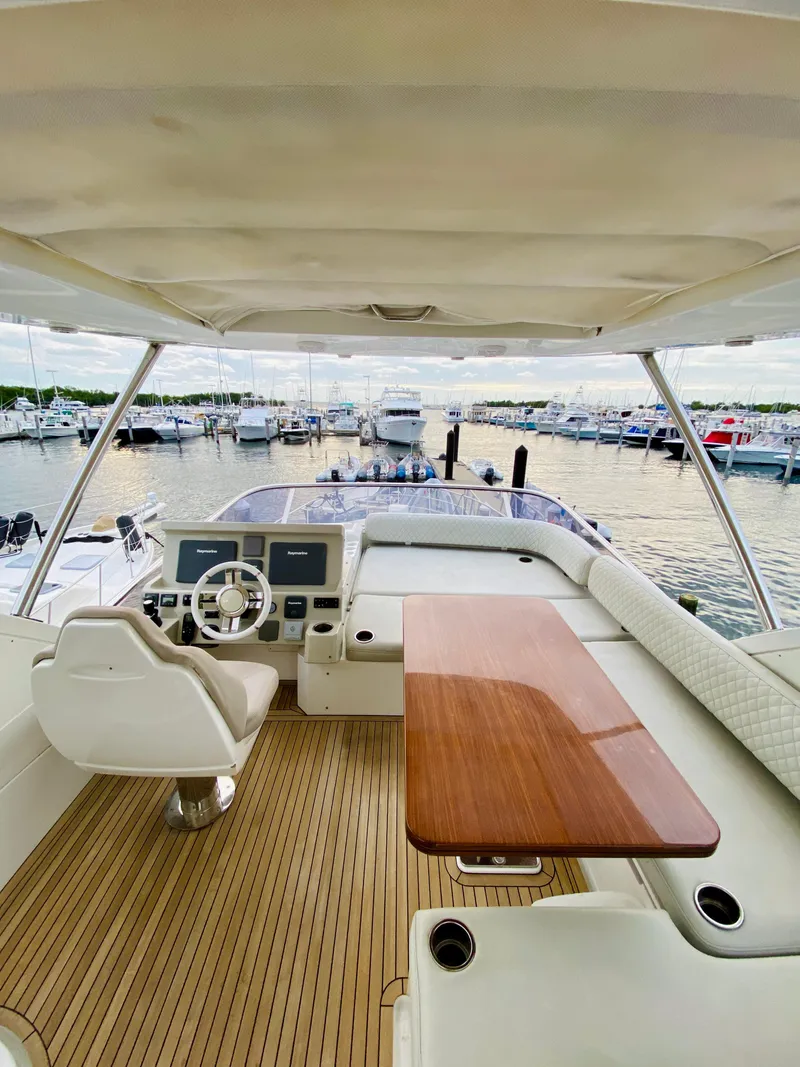 Slide: The Image of Luxurious 2015 Azimut 50 yacht interior with helm and wooden table, docked at marina. - 18