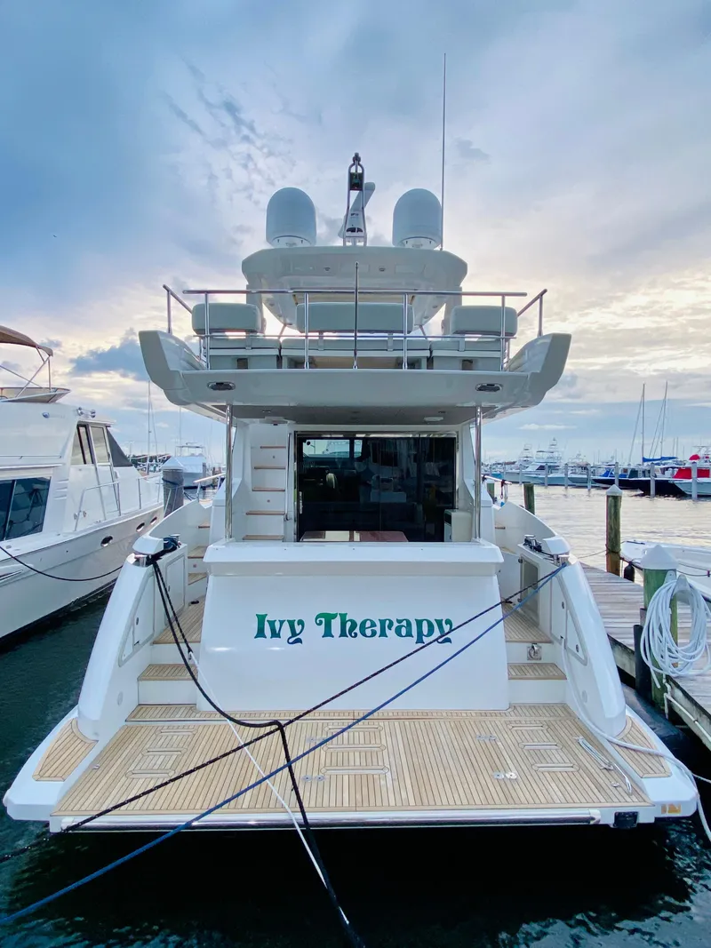 Slide: The Image of Azimut 50 yacht, 2015 model, docked at marina, named "Ivy Therapy." - 2