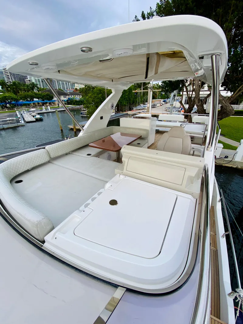 Slide: The Image of 2015 Azimut 50 yacht with spacious deck and seating area, docked by the water. - 21