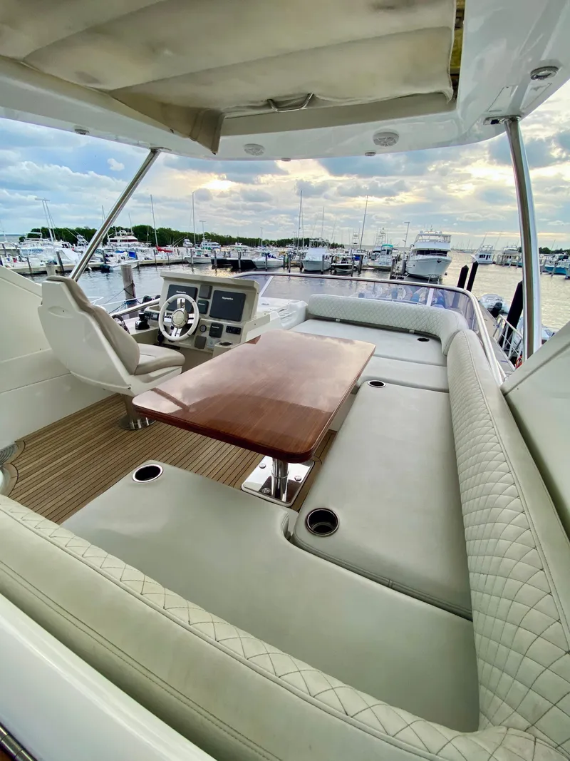 Slide: The Image of Luxurious 2015 Azimut 50 yacht interior with elegant seating and helm, docked at marina. - 24