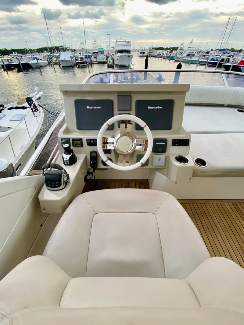 Slide: The Image of Azimut 50 yacht helm, 2015 model, with dual Raymarine displays in a marina setting. - 25