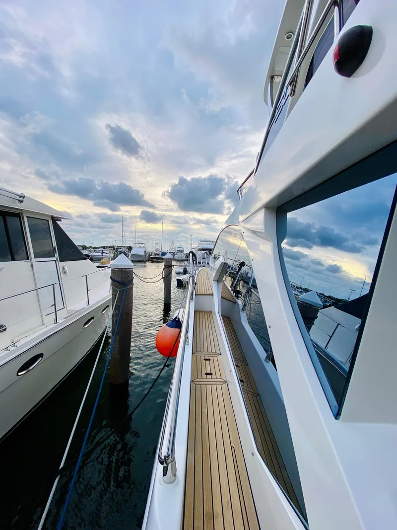 Slide: The Image of 2015 Azimut 50 yacht docked at marina under cloudy sky. - 28
