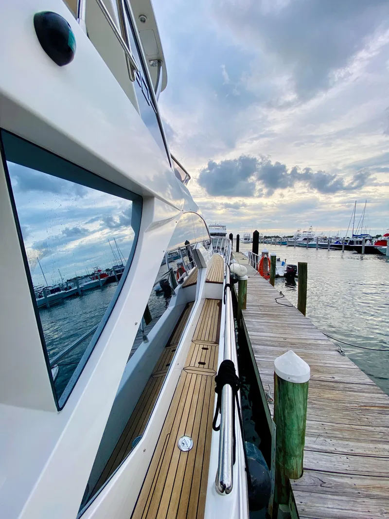 Slide: The Image of Azimut 50 yacht docked at marina, 2015 model, with scenic waterfront view. - 29