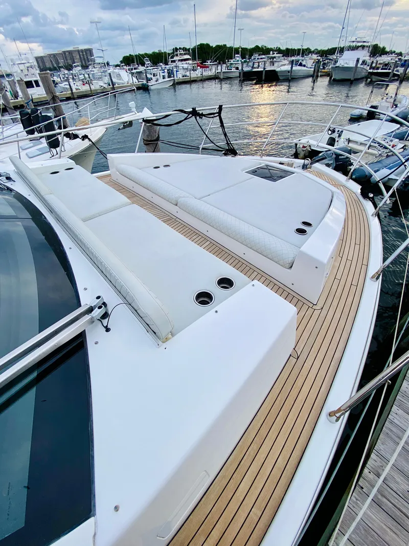 Slide: The Image of Azimut 50 yacht 2015 model, spacious deck with white seating, docked at marina. - 30