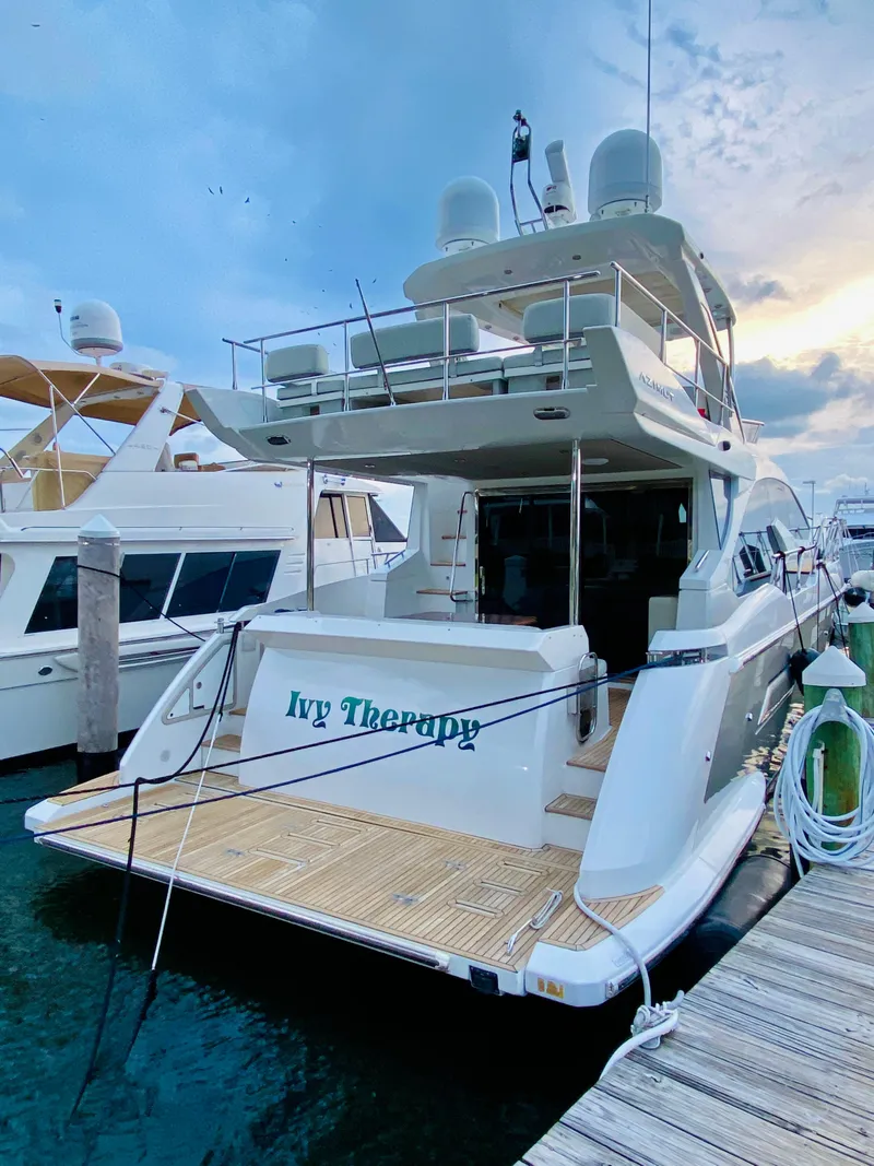 Slide: The Image of 2015 Azimut 50 yacht docked at marina, named "Ivy Therapy." - 4