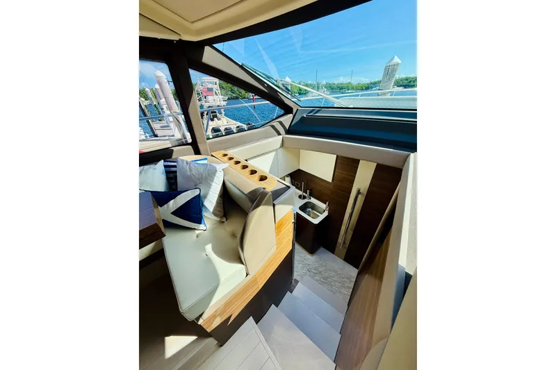 Slide: The Image of Interior of 2015 Azimut 50 yacht, featuring seating and a compact kitchenette. - 46