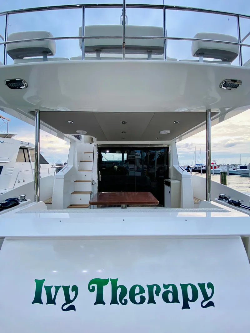 Slide: The Image of Azimut 50 yacht, 2015 model, named "Ivy Therapy" docked at a marina. - 5