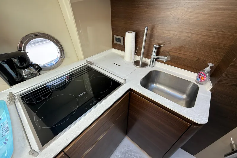 Slide: The Image of Modern kitchen in 2015 Azimut 50 yacht with stove, sink, and porthole window. - 50