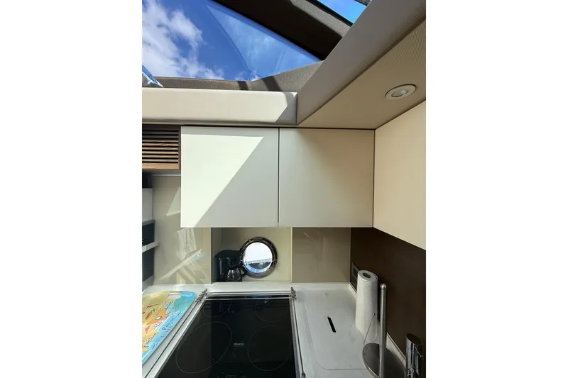 Slide: The Image of Modern kitchen interior of 2015 Azimut 50 yacht with skylight and sleek cabinetry. - 51