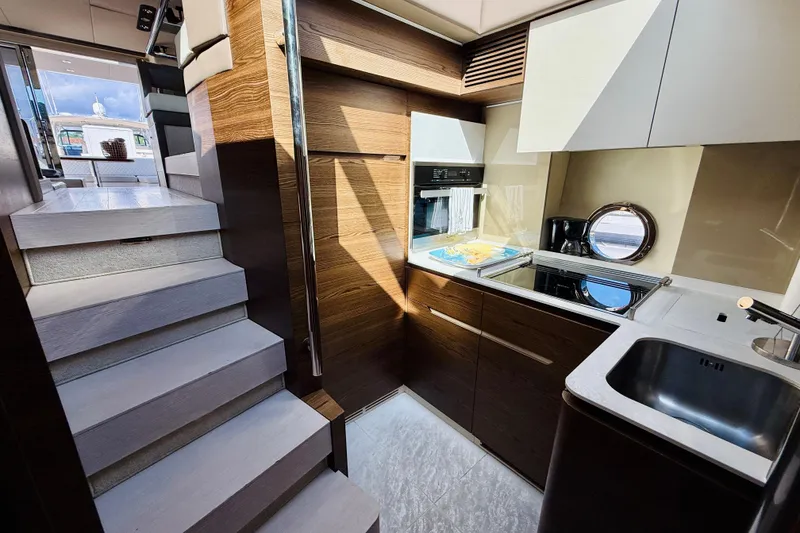 Slide: The Image of Luxurious 2015 Azimut 50 yacht interior with modern kitchen and elegant wooden finishes. - 53