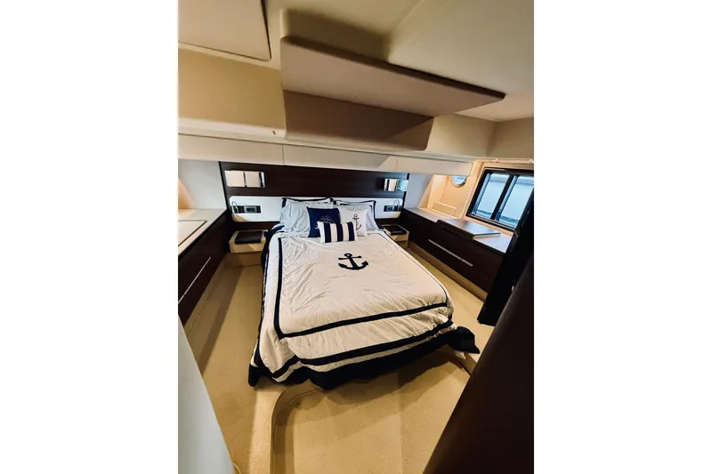 Slide: The Image of Luxurious bedroom interior of 2015 Azimut 50 yacht with nautical-themed bedding. - 55