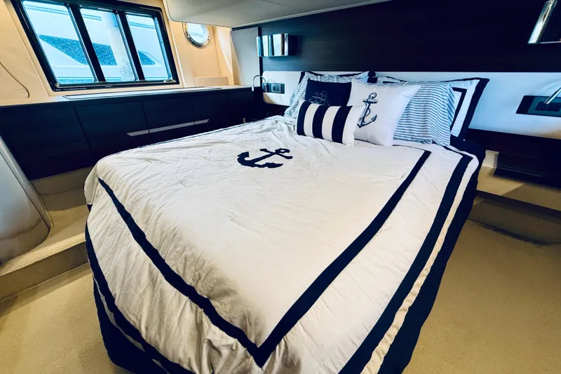 Slide: The Image of Luxurious bedroom interior of 2015 Azimut 50 yacht with nautical-themed bedding. - 56