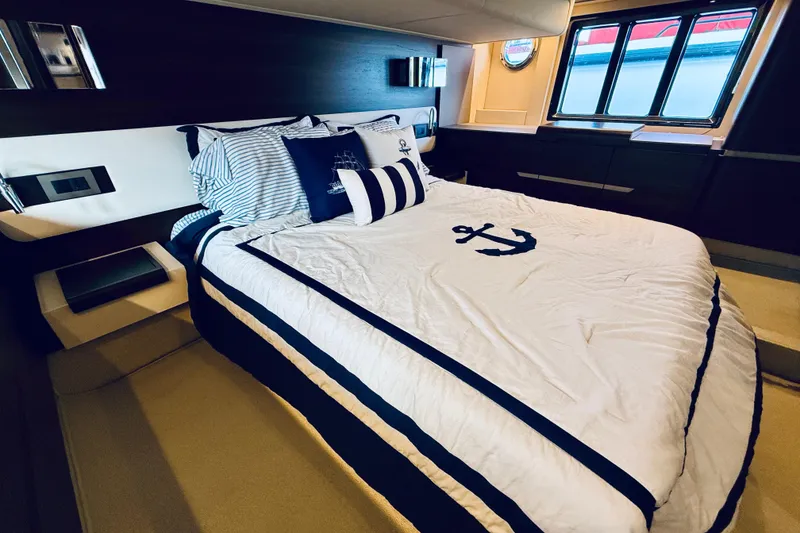 Slide: The Image of Luxurious bedroom interior of 2015 Azimut 50 yacht with nautical-themed bedding. - 57
