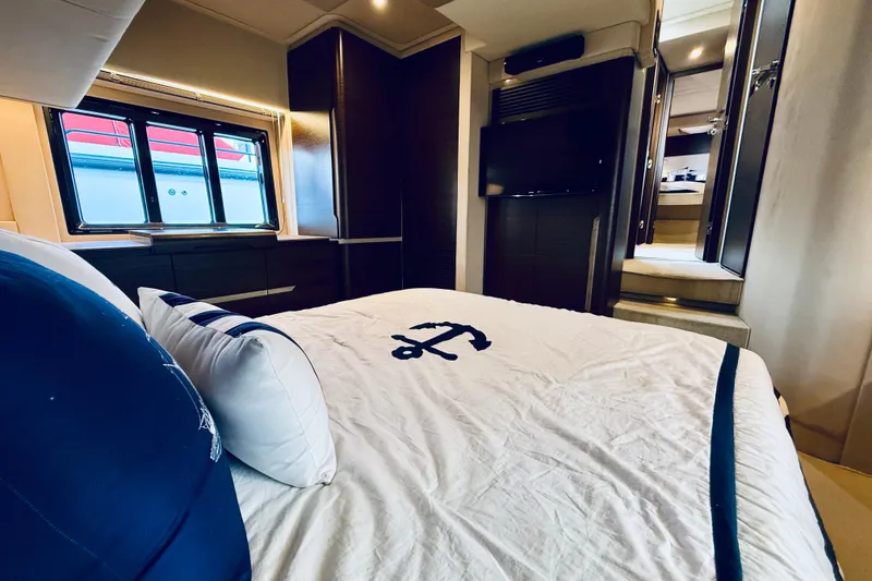 Slide: The Image of Luxurious bedroom interior of 2015 Azimut 50 yacht with nautical-themed bedding. - 58